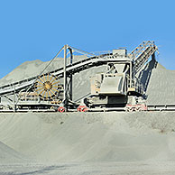 Trucks at work in porphyry quarry, open-pit mine for the production of gravel for road building at Lessen / Lessines, Belgium
